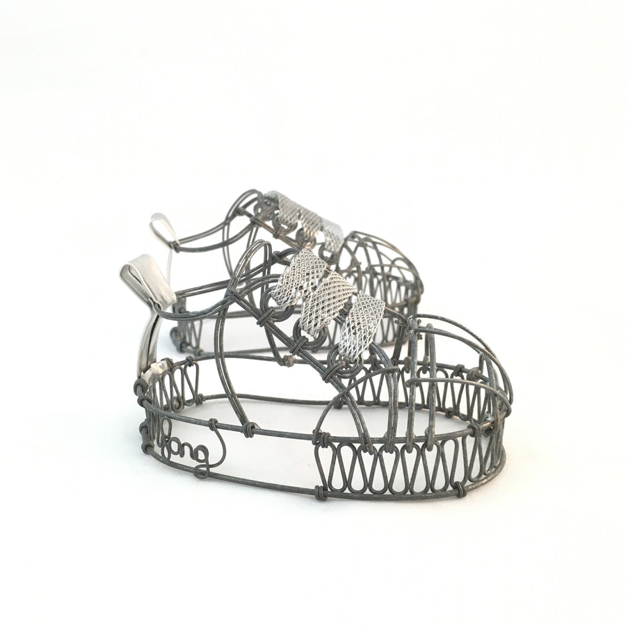 Wire baby shoes by Natalie Fong