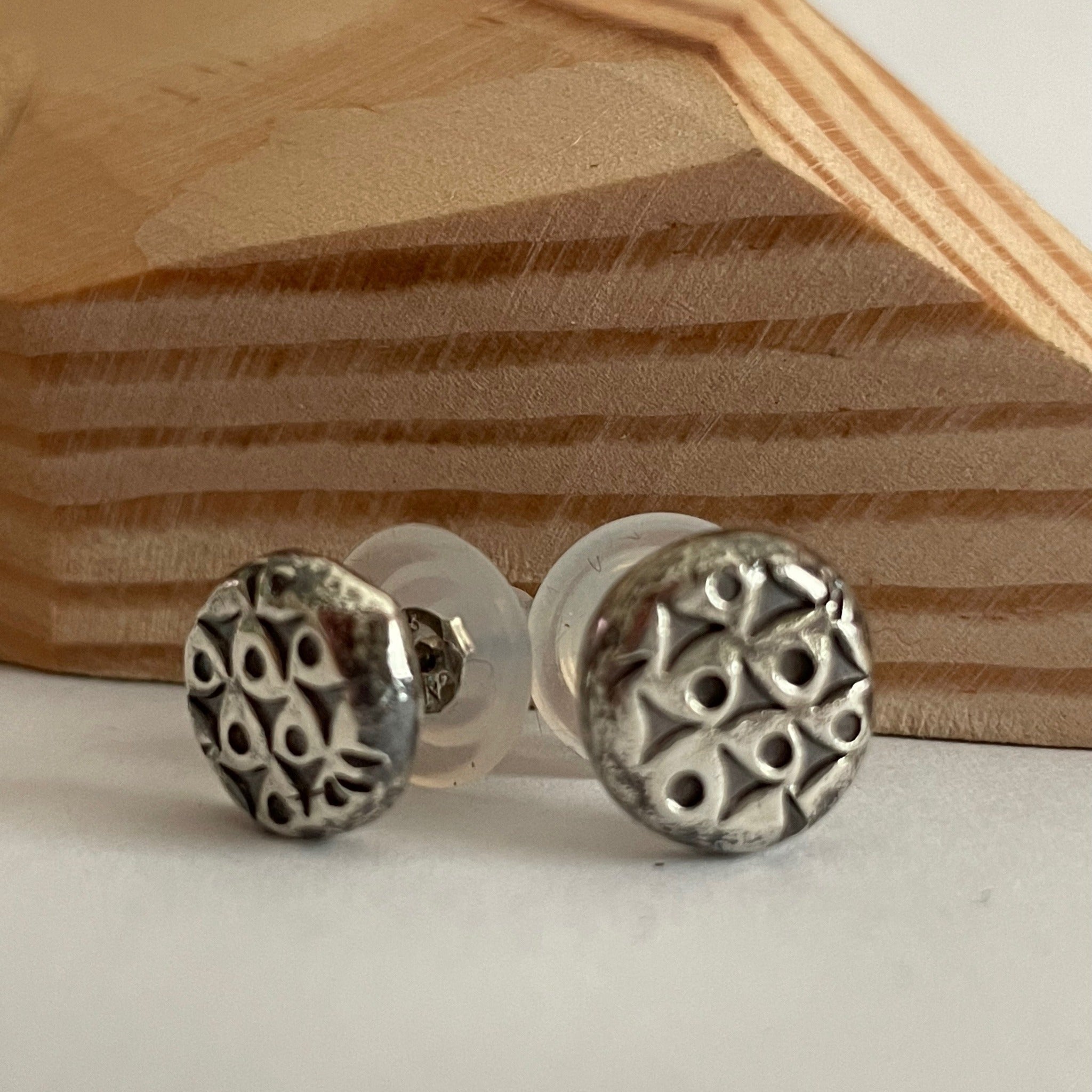 Modern melted silver, hand forged, stud earrings handmade by Pam de Groot